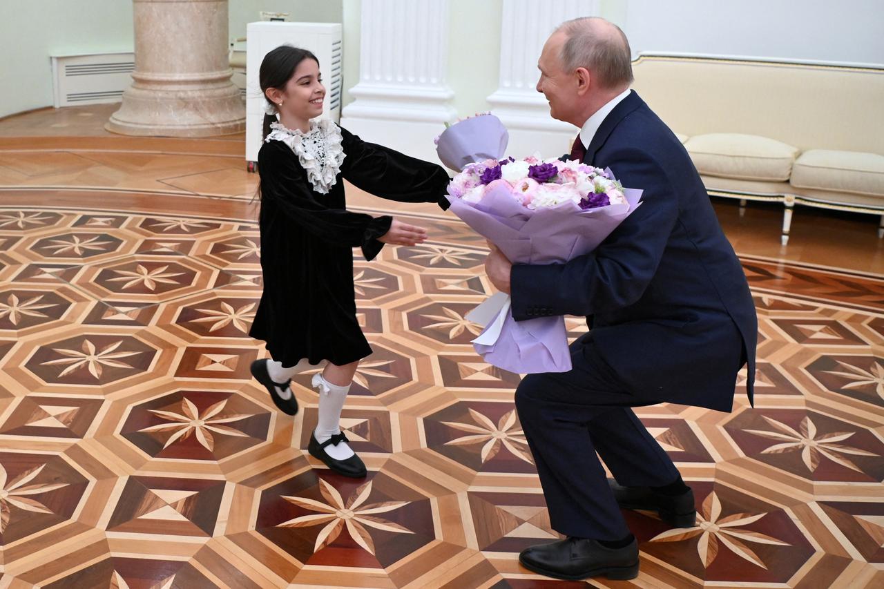 Russian President Vladimir Putin meets with Raisat Akipova, an 8-year-old girl from Dagestan, at the Kremlin in Moscow