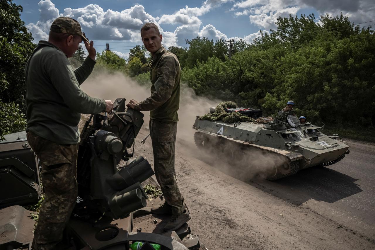 Ukrainian service members ride an Armoured Personnel Carrier, amid Russia's attack on Ukraine, near the Russian border in Sumy region