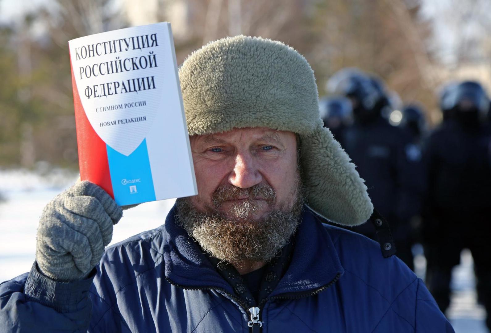 OMSK, RUSSIA - JANUARY 31, 2021: A man holds a copy of the Constitution of the Russian Federation during an unauthorised protest in support of the detained opposition activist Alexei Navalny. Navalny, who had been handed a suspended sentence in the Yves Rocher case in 2014, was detained at Sheremetyevo Airport near Moscow on 17 January 2021 for violating probation conditions. A court ruled that Navalny be put into custody until 15 February 2021. Yevgeny Sofiychuk/TASS Photo via Newscom Newscom/PIXSELL