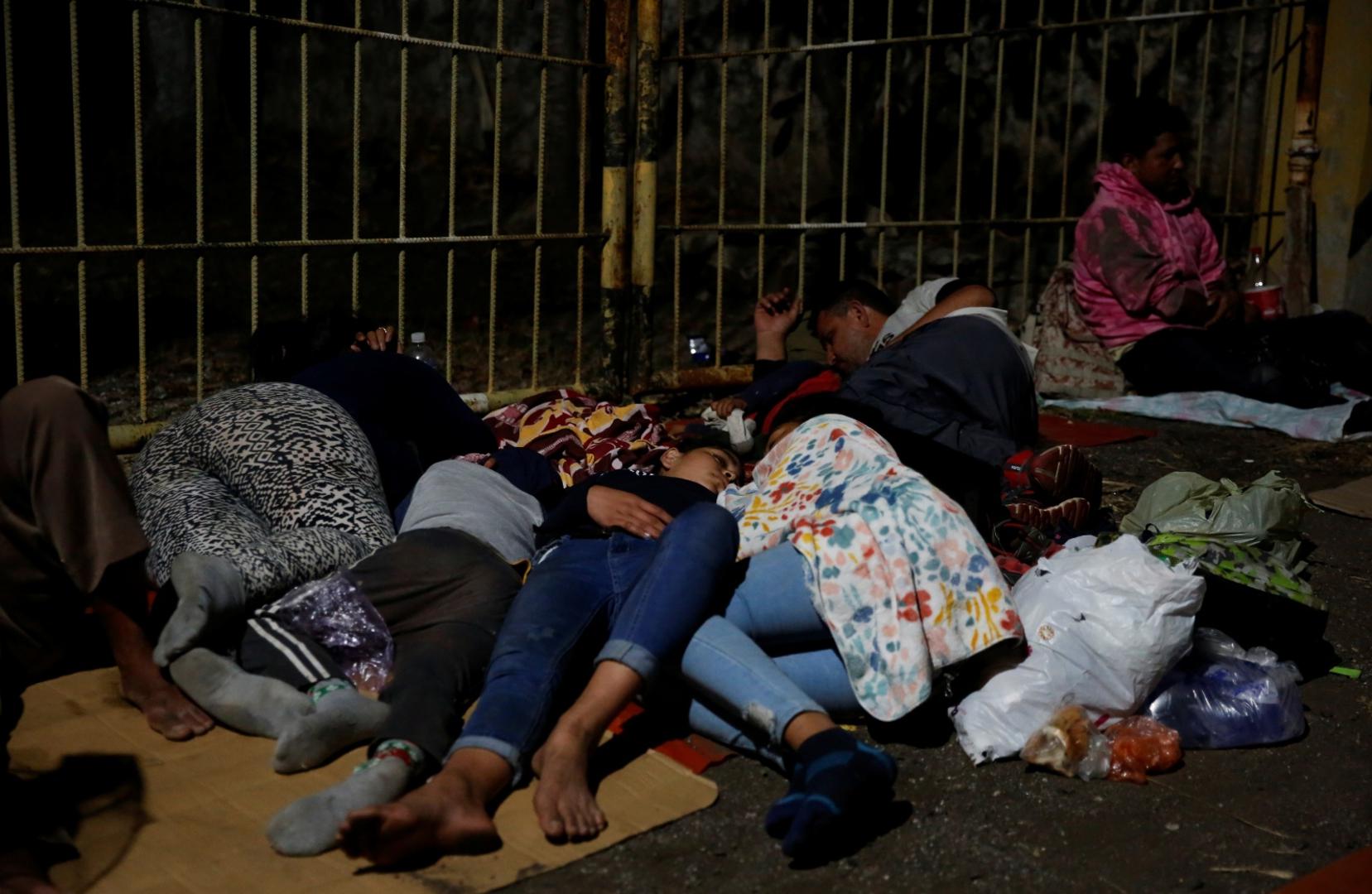 Hondurans take part in a new caravan of migrants set to head to the United States Hondurans taking part in a new caravan of migrants set to head to the United States, sleep while taking a break in Vado Hondo, Guatemala January 16, 2021. REUTERS/Luis Echeverria LUIS ECHEVERRIA