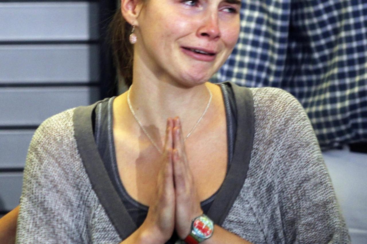 'Amanda Knox cries and gestures to friends during a news conference at Sea-Tac International Airport, Washington after landing there on a flight from Italy, October 4, 2011. Knox returned home to Seat