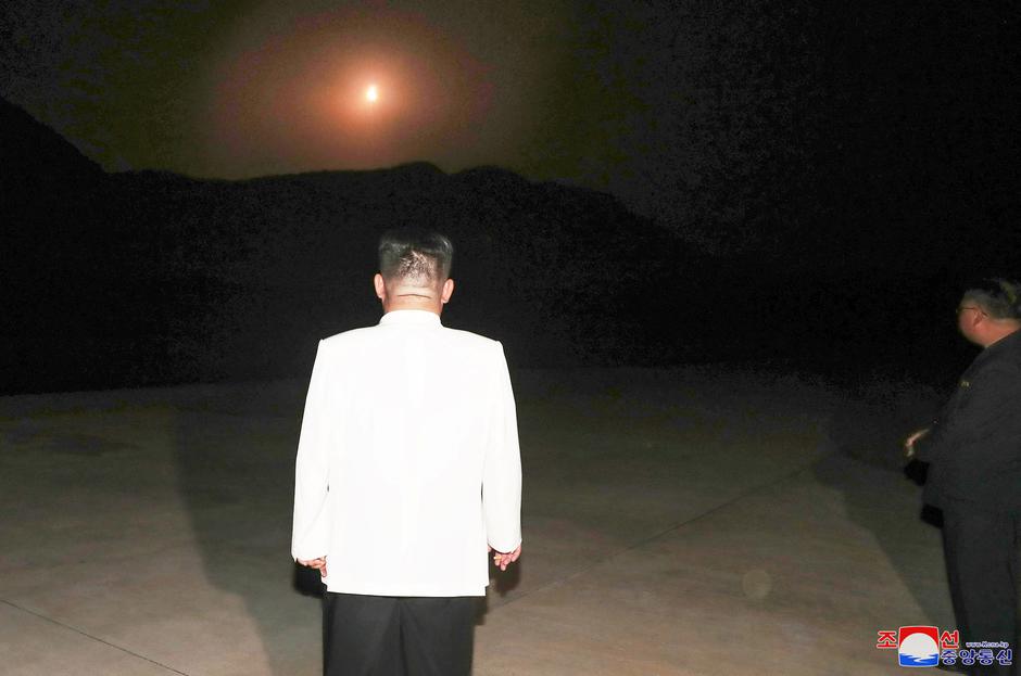 North Korea's leader Kim Jong Un oversees a missile launch at an undisclosed location in North Korea