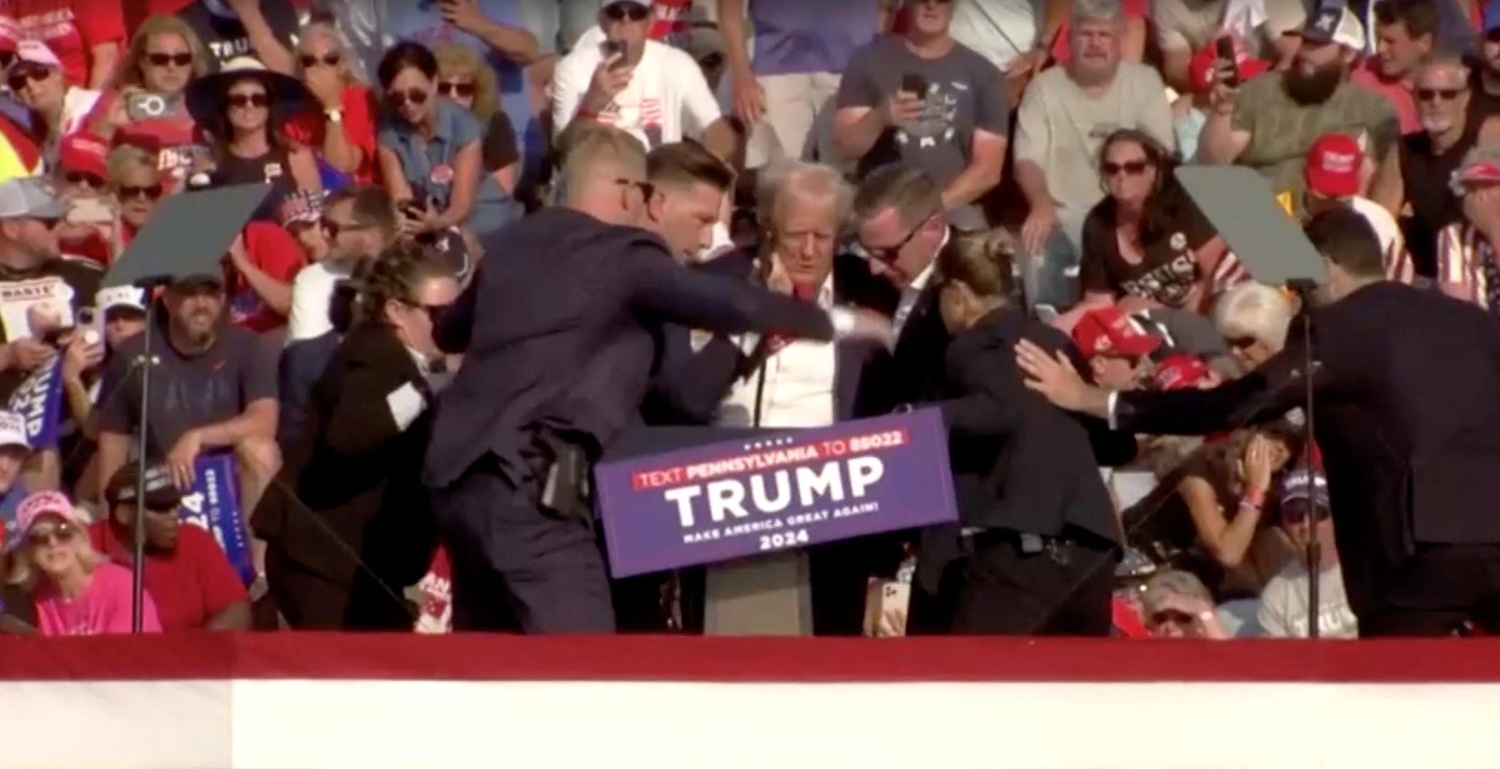 Republican presidential candidate and former U.S. President Donald Trump rushed from rally after gunfire rings out during a campaign rally at the Butler Farm Show in Butler, Pennsylvania, U.S., July 13, 2024, in this screen grab taken from a video. ABC/US Network Pool/ Handout via REUTERS ATTENTION EDITORS - THIS PICTURE WAS PROVIDED BY A THIRD PARTY. NO RESALES. NO ARCHIVES.   MANDATORY CREDIT Photo: ABC/US Network Pool/REUTERS