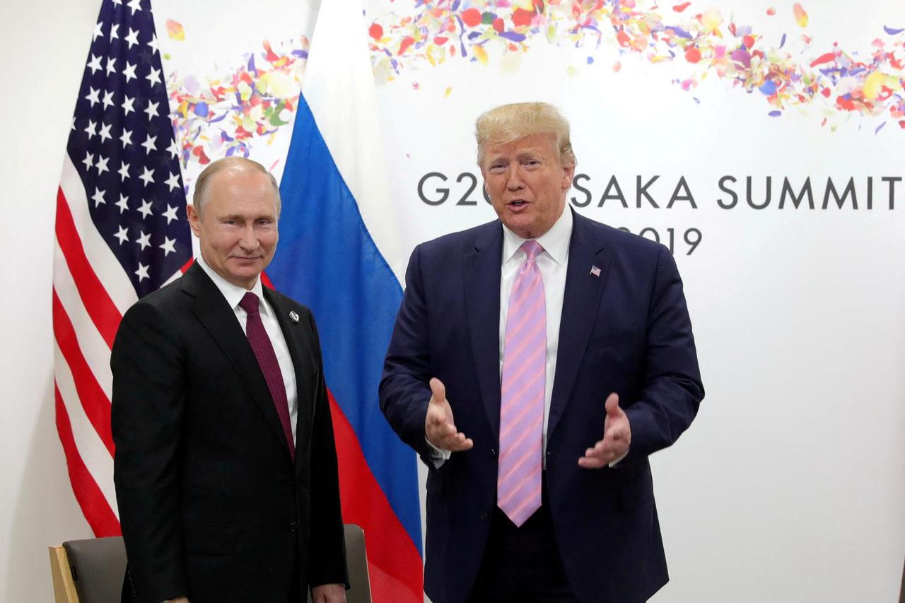 FILE PHOTO: Russia's President Vladimir Putin and U.S. President Donald Trump attend a meeting on the sidelines of the G20 summit in Osaka