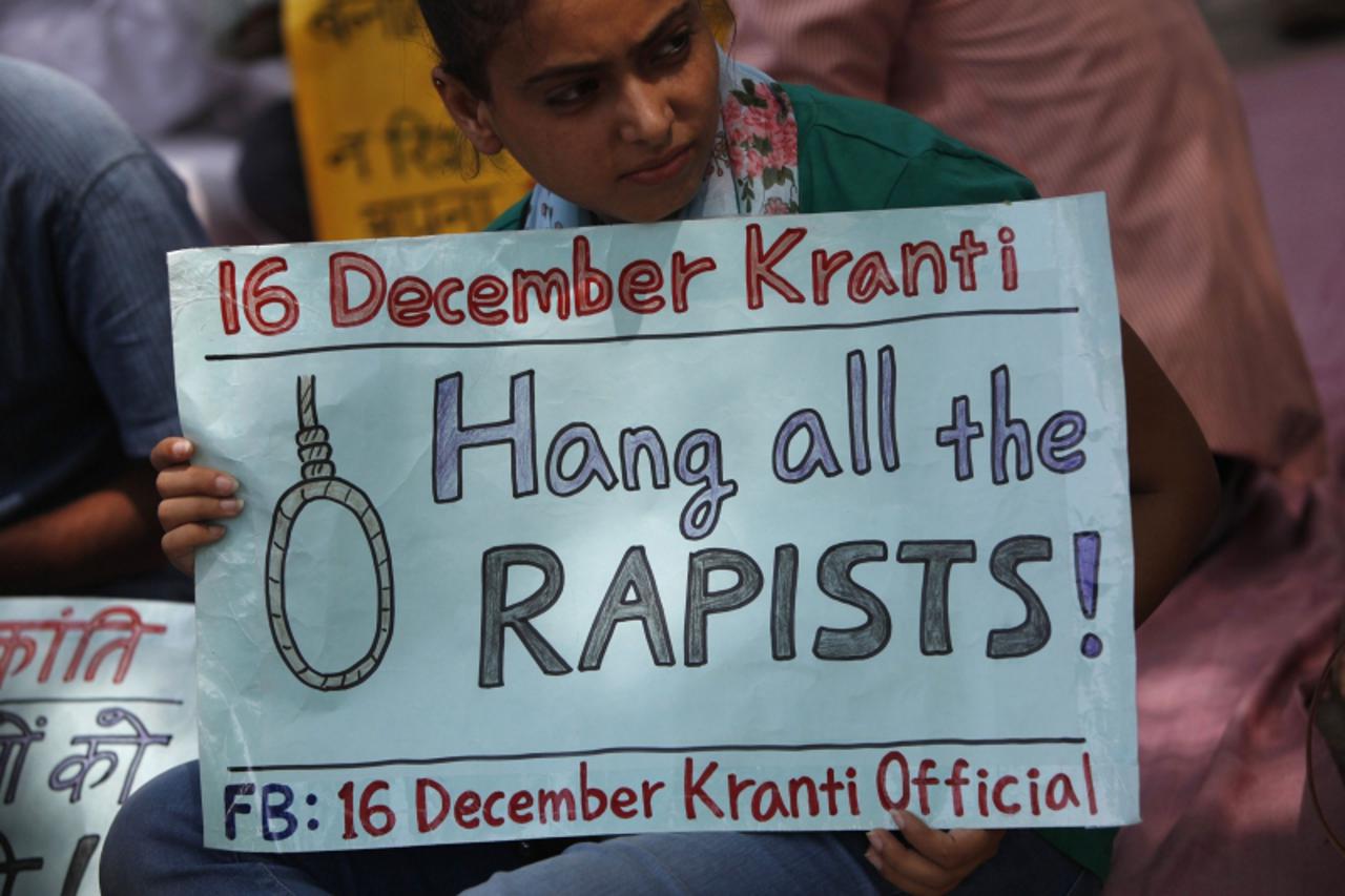 'A demonstrator holds a placard during a protest against the verdict of a teenager, who was sentenced to three years in juvenile detention, in New Delhi September 1, 2013. The Indian teenager was sent