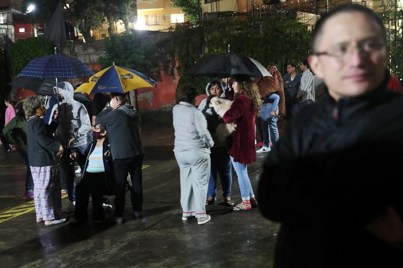 People react during a quake in Mexico City