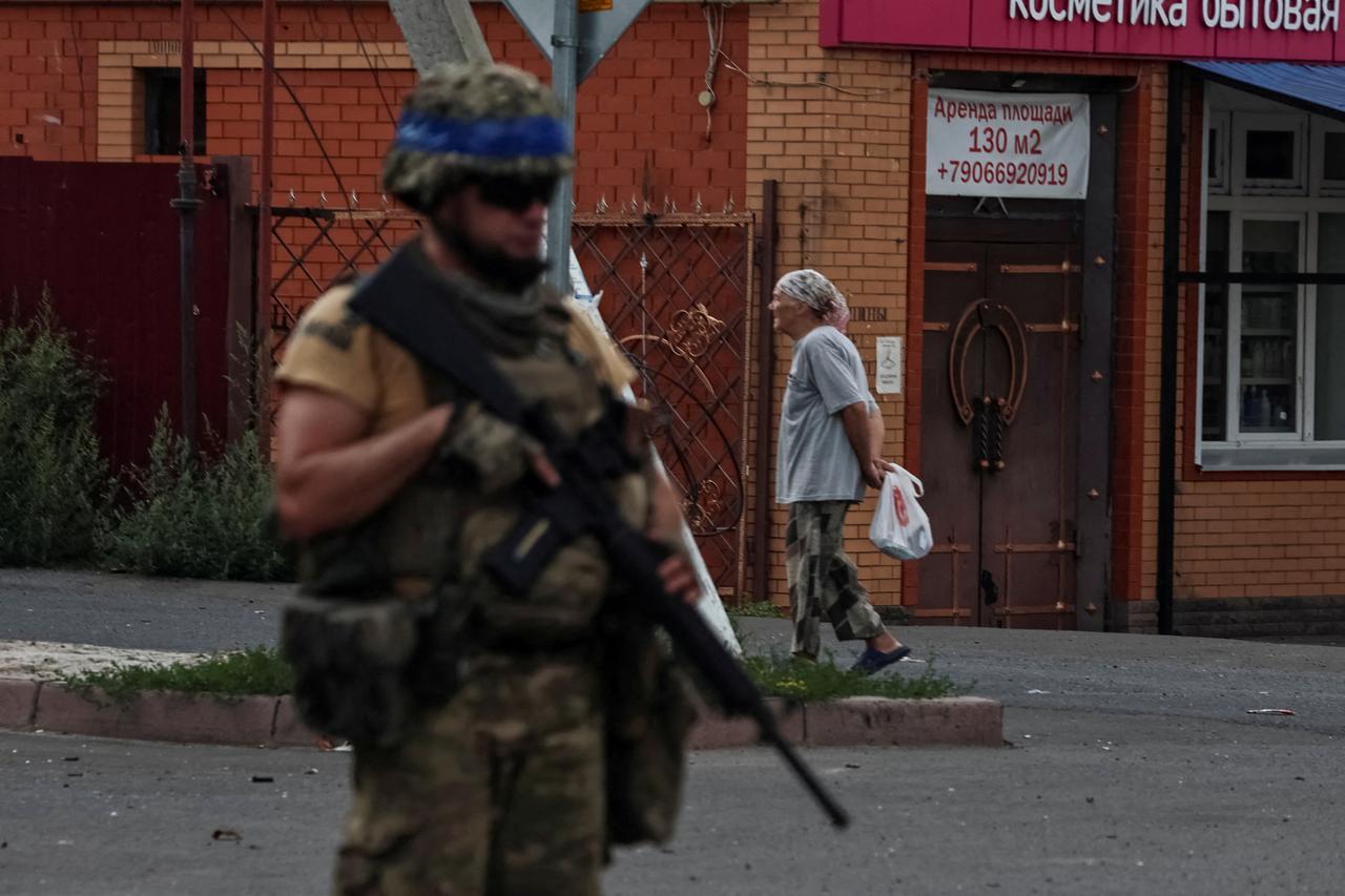 FILE PHOTO: A Ukrainian serviceman patrols in the town of Sudzha