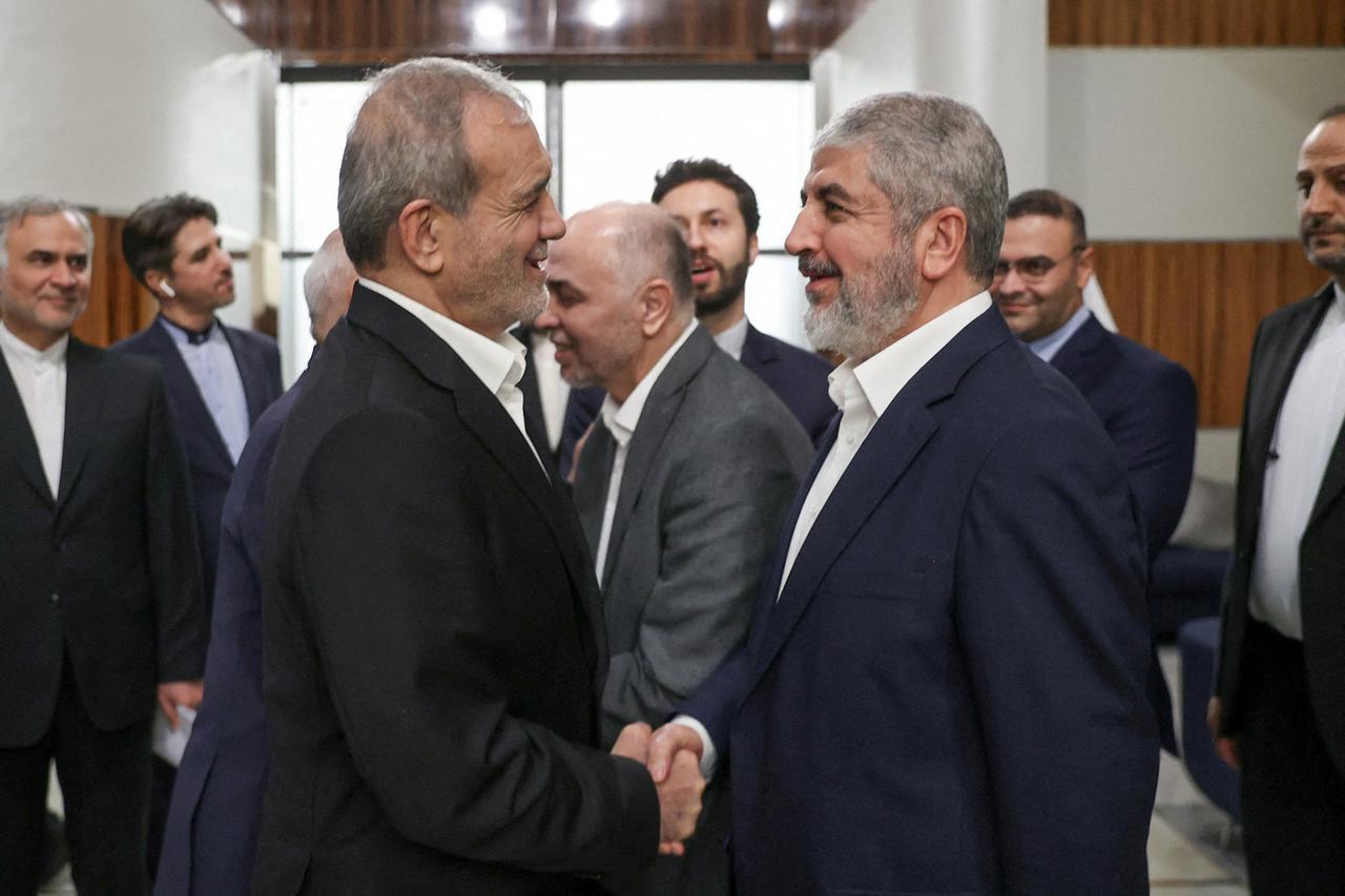 Iran's President Masoud Pezeshkian meets with Hamas leader Khaled Mashal, in Doha