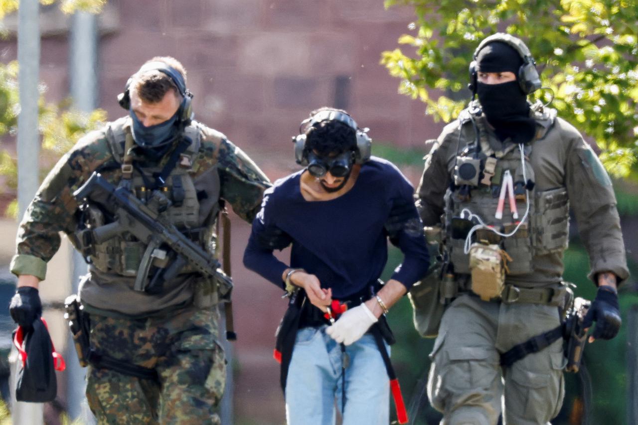 Law enforcement members guard the perimeter of the home of Republican presidential candidate and former U.S. President Donald Trump's shooting suspect