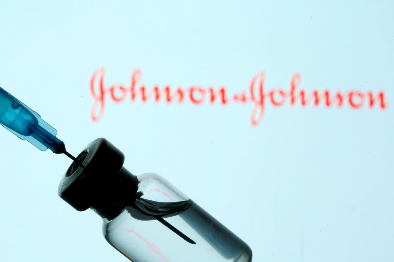 FILE PHOTO: Vial and sryinge are seen in front of displayed Johnson&Johnson logo in this illustration taken