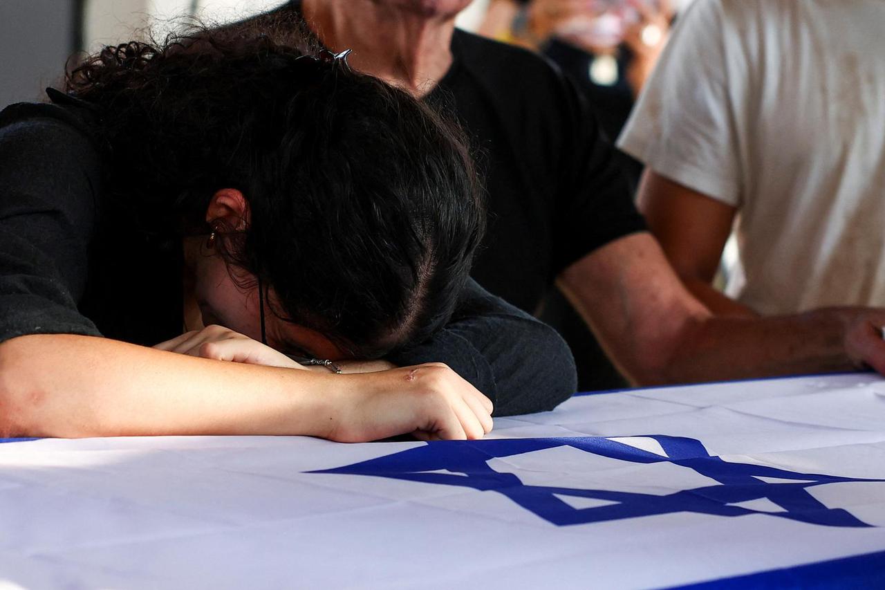 Mourners pay their respects to Yoram Metzger, at his funeral in Kibbutz Nir Oz