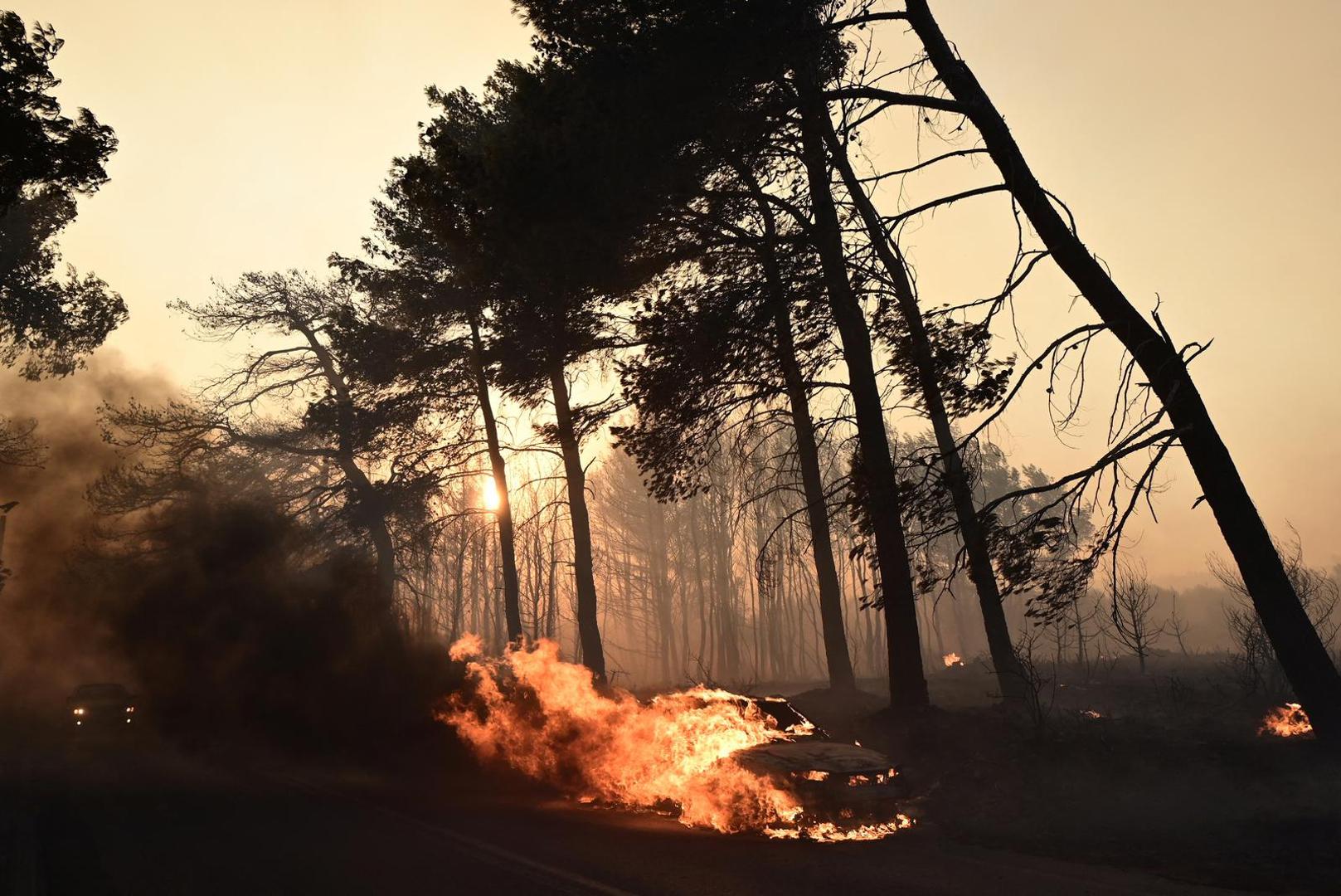 A car is seen in flames as a wildfire burns in the village of Varnavas, near Athens, Greece, August 11, 2024. Michalis Karagiannis/Eurokinissi via REUTERS ATTENTION EDITORS - THIS IMAGE HAS BEEN SUPPLIED BY A THIRD PARTY. NO RESALES. NO ARCHIVES. GREECE OUT. NO EDITORIAL OR COMMERCIAL SALES IN GREECE. Photo: Michalis Karagiannis/REUTERS