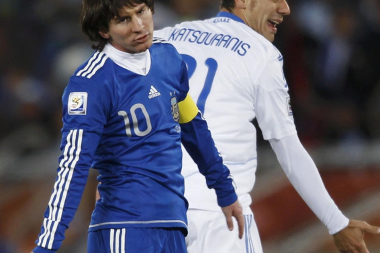 'Greece\'s Kostas Katsouranis (rear) reacts next to Argentina\'s Lionel Messi during a 2010 World Cup Group B soccer match at Peter Mokaba stadium in Polokwane June 22, 2010. REUTERS/Amr Abdallah Dals