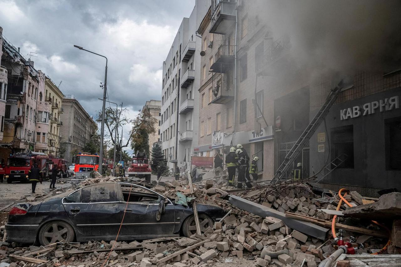 FILE PHOTO: Firefighters work at the site of a residential building hit by a Russian military strike in Kharkiv