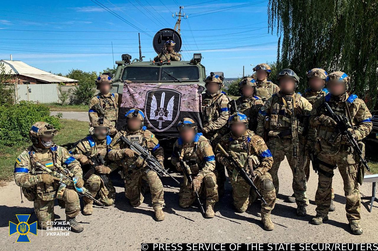 Service members of the State Security Service of Ukraine pose for a picture in the recently liberated town of Kupiansk