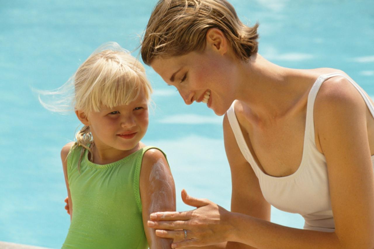 'Mother and daughter by swimming pool'