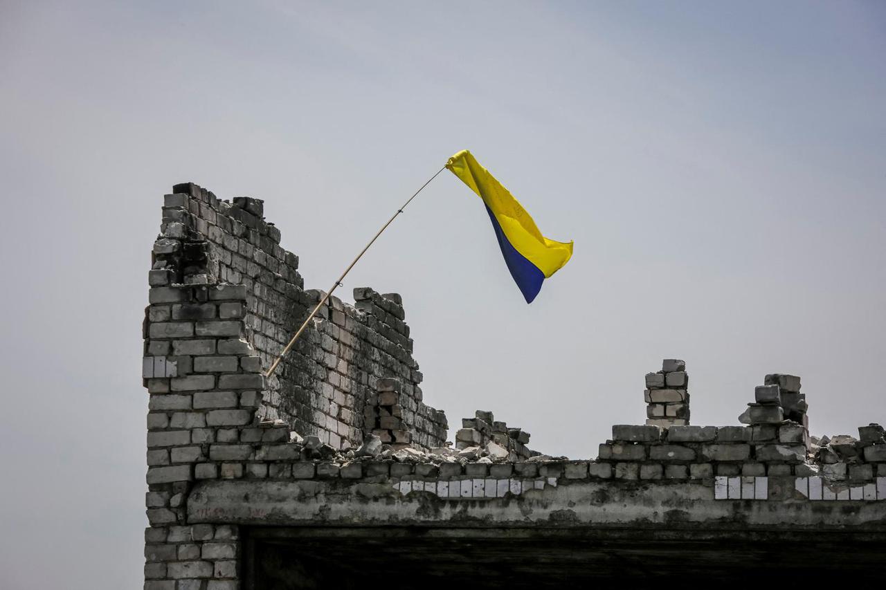 A Ukrainian national flag is seen near the front line in the newly liberated village Neskuchne