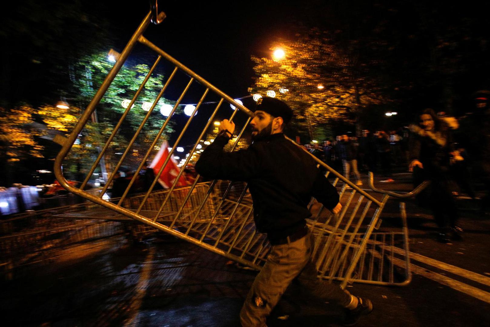 A protestor throws a piece of the protective fence toward police during a protest against the adoption of a law to limit presidential powers in Podgorica, Montenegro, December 12, 2022. REUTERS/Stevo Vasiljevic Photo: STEVO VASILJEVIC/REUTERS