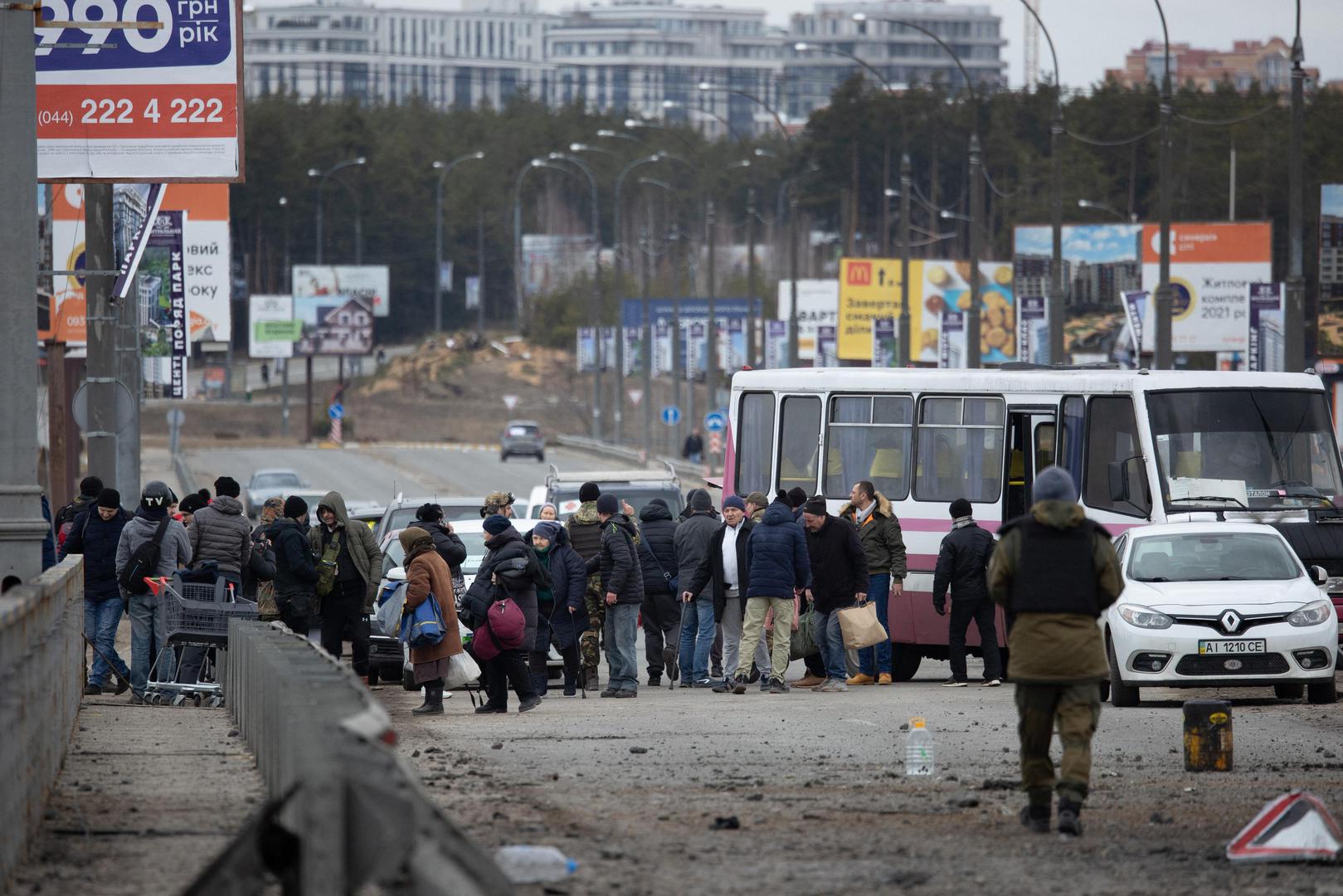 Soldiers help people cross a destroyed bridge as they evacuate the city of Irpin, northwest of Kyiv, during heavy shelling and bombing on March 5, 2022, 10 days after Russia launched a military invasion on Ukraine. Photo by Raphael Lafargue/ABACAPRESS.COM