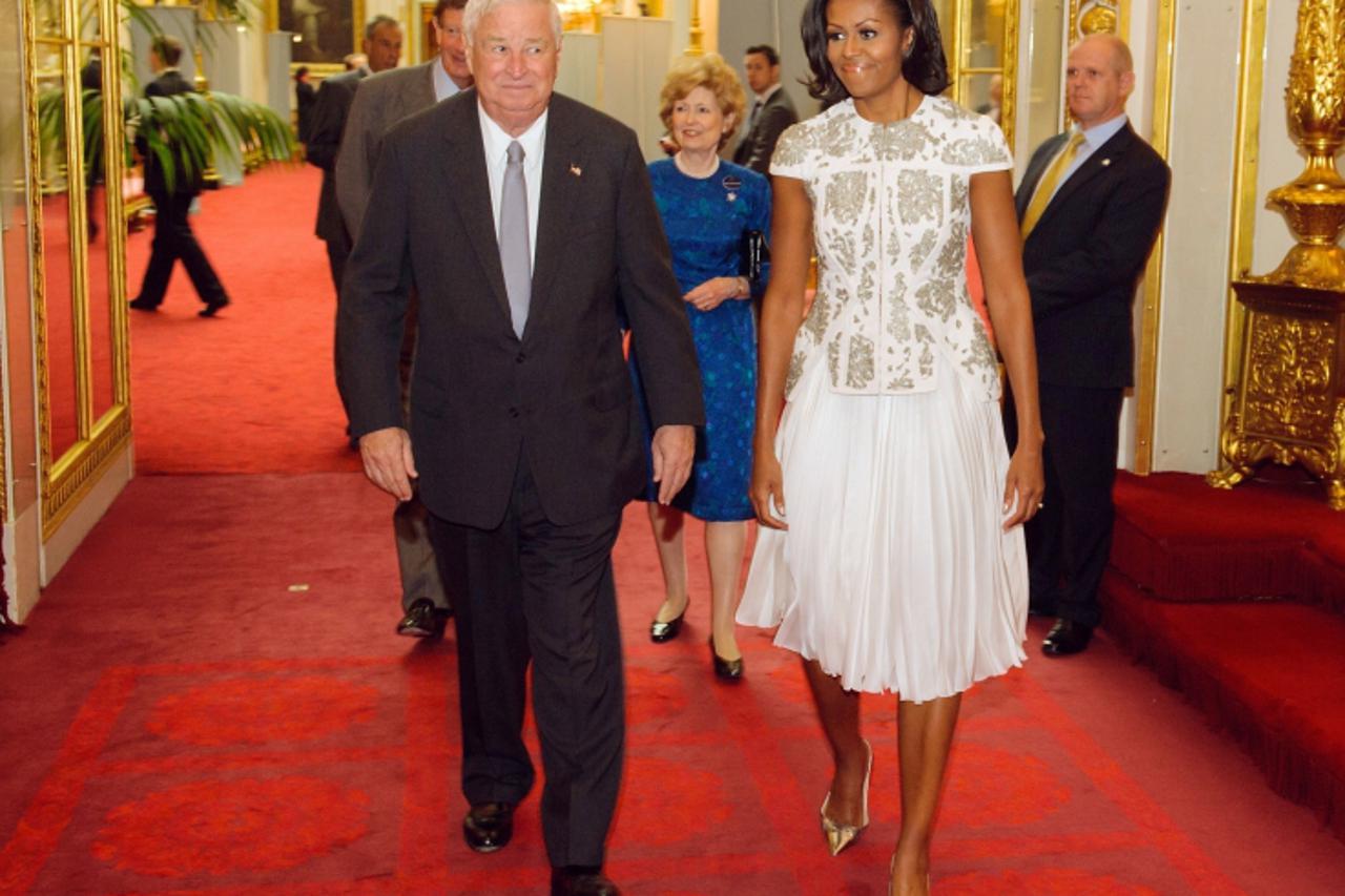 'US First Lady Michelle Obama (R) and US ambassador in Great Britain Louis Susman arrive at a reception at the Buckingham Palace, in London, on July 27, 2012 to welcome Heads of State and Heads of Gov