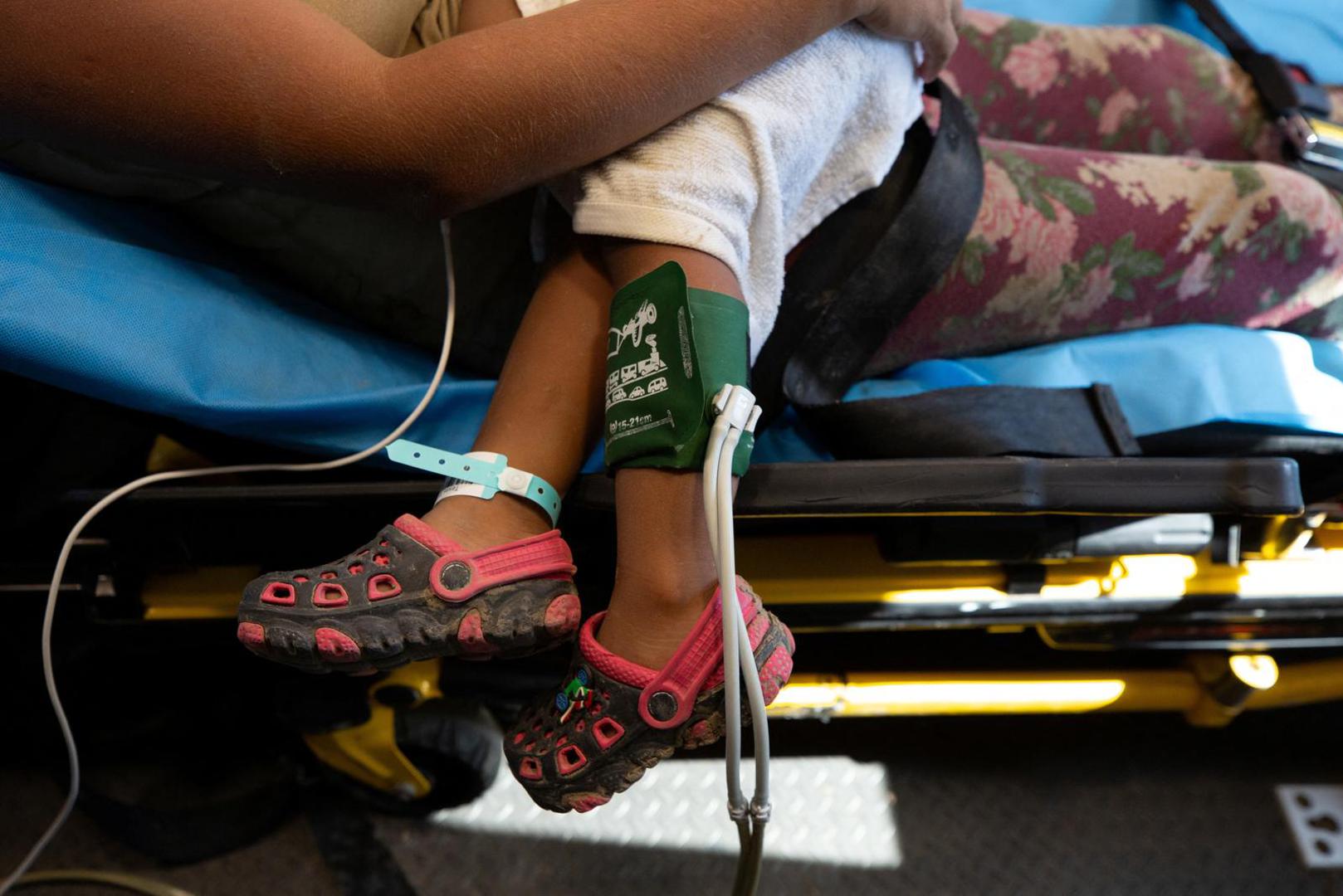 A blood pressure monitor and hospital bracelet are wrapped around a two-year-old's legs as he and his mother are transported to the hospital after the child suffered heat exhaustion, a seizure and difficulty breathing on the banks of the Rio Grande river, amid a heatwave, in Eagle Pass, Texas, U.S., July 10, 2023.  REUTERS/Kaylee Greenlee Beal Photo: KAYLEE GREENLEE BEAL/REUTERS