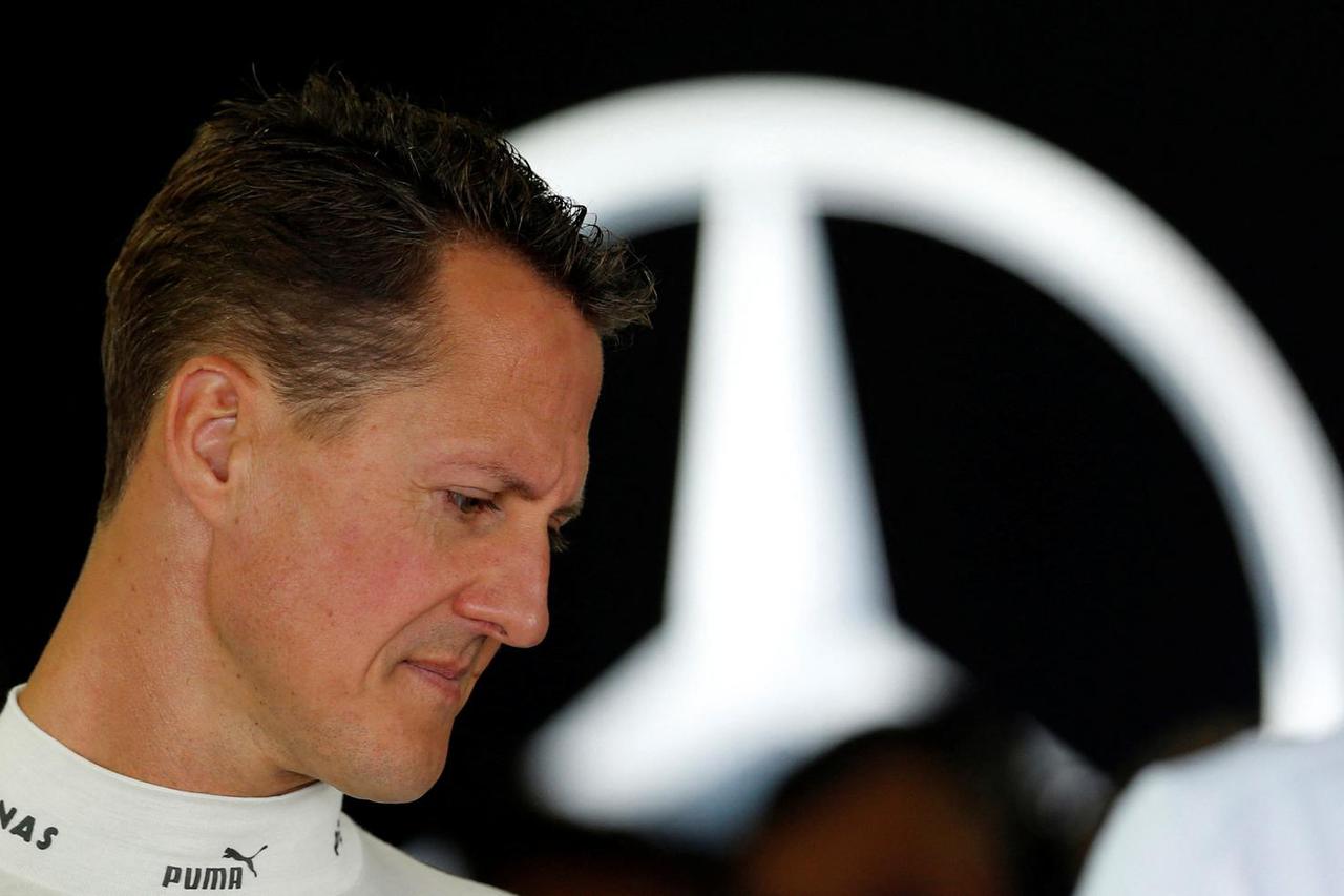 FILE PHOTO: Mercedes Formula One driver Schumacher stands inside his team garage during the first practice session of the Japanese F1 Grand Prix at the Suzuka circuit