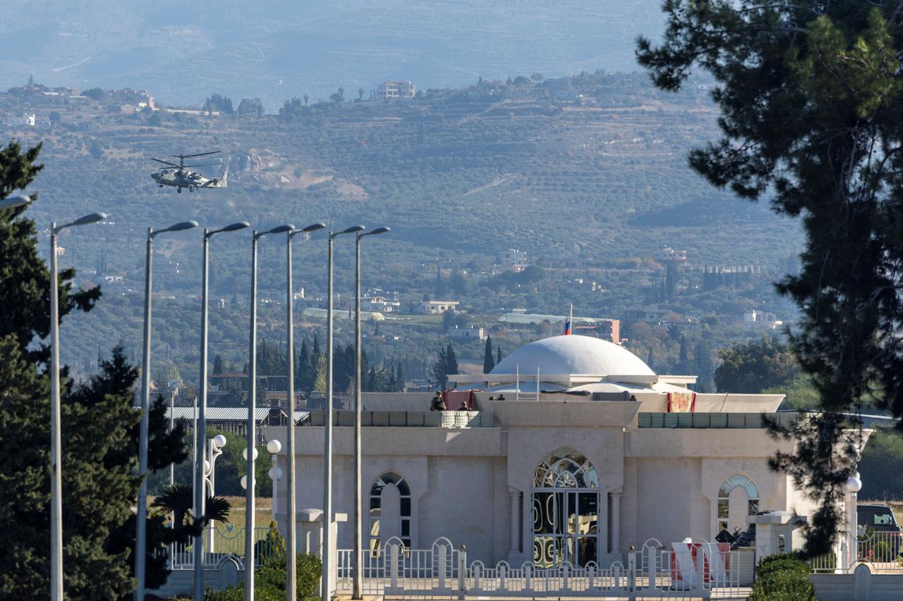 A Russian military helicopter Kamov KA-50 flies over Hmeimim air base in Syria's coastal Latakia