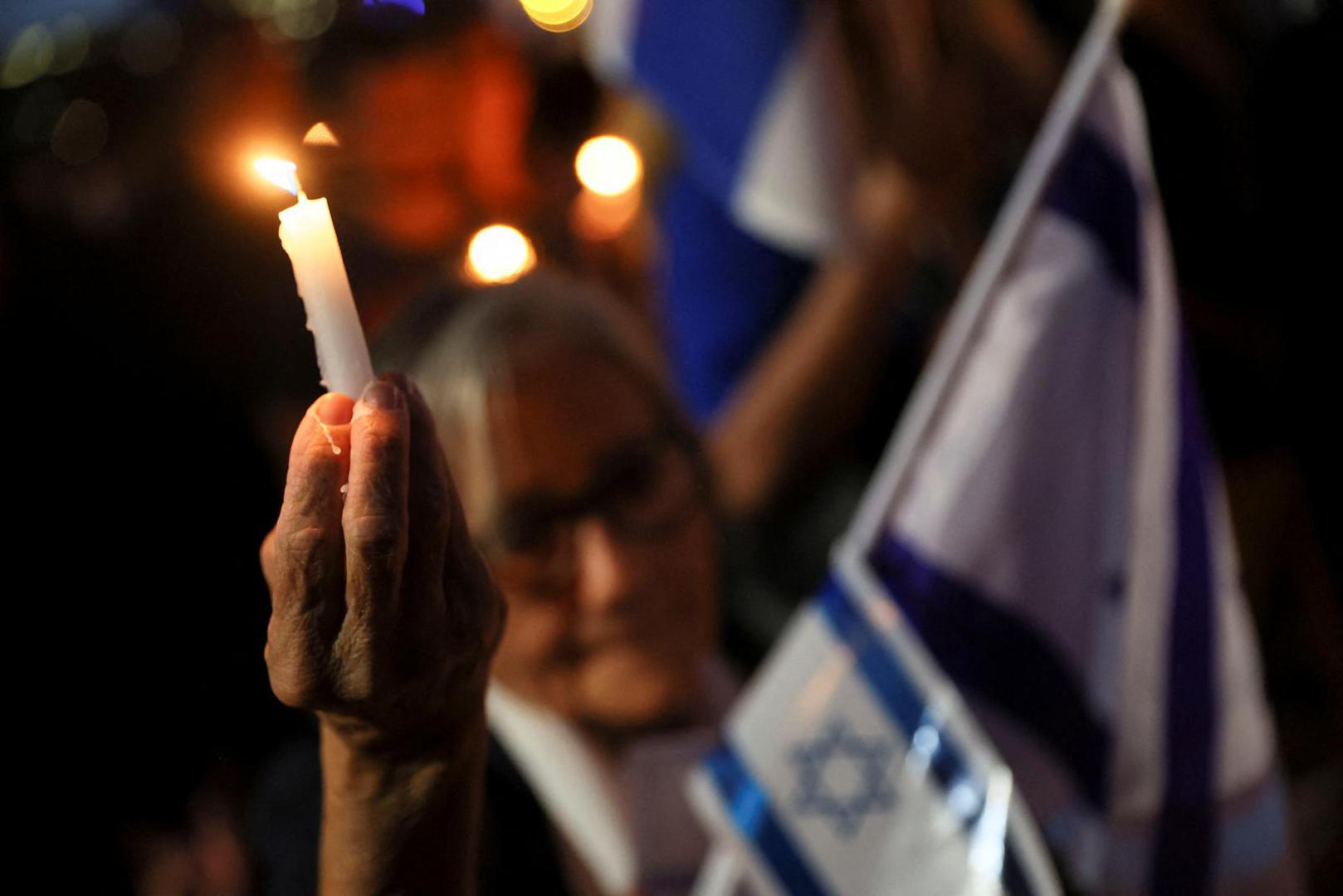 A demonstrator holds a candle during a demonstration organised by the Switzerland-Israel Association against the attacks by Hamas, outside the United Nations in Geneva, Switzerland, October 11, 2023. REUTERS/Denis Balibouse Photo: DENIS BALIBOUSE/REUTERS