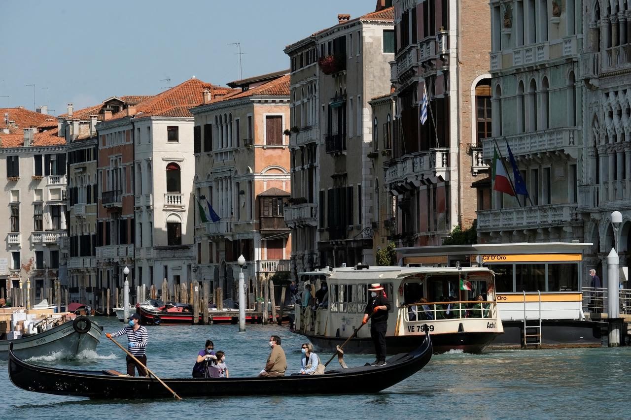 Gondoliers resume their service on the Grand Canal as Italy eases some more of the lockdown measures put in place during the coronavirus disease (COVID-19) outbreak, in Venice