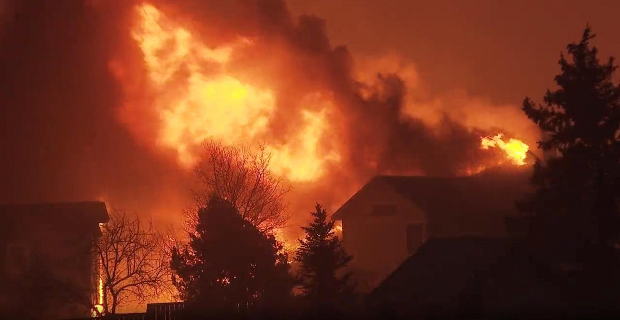 A house burns as a wind-driven wildfire forced evacuation of the Superior suburb of Boulder, Colorado, U.S. December 30,2021 in this still image obtained from a social media video. Eric English/via REUTERS THIS IMAGE HAS BEEN SUPPLIED BY A THIRD PARTY. MANDATORY CREDIT. NO RESALES. NO ARCHIVES.