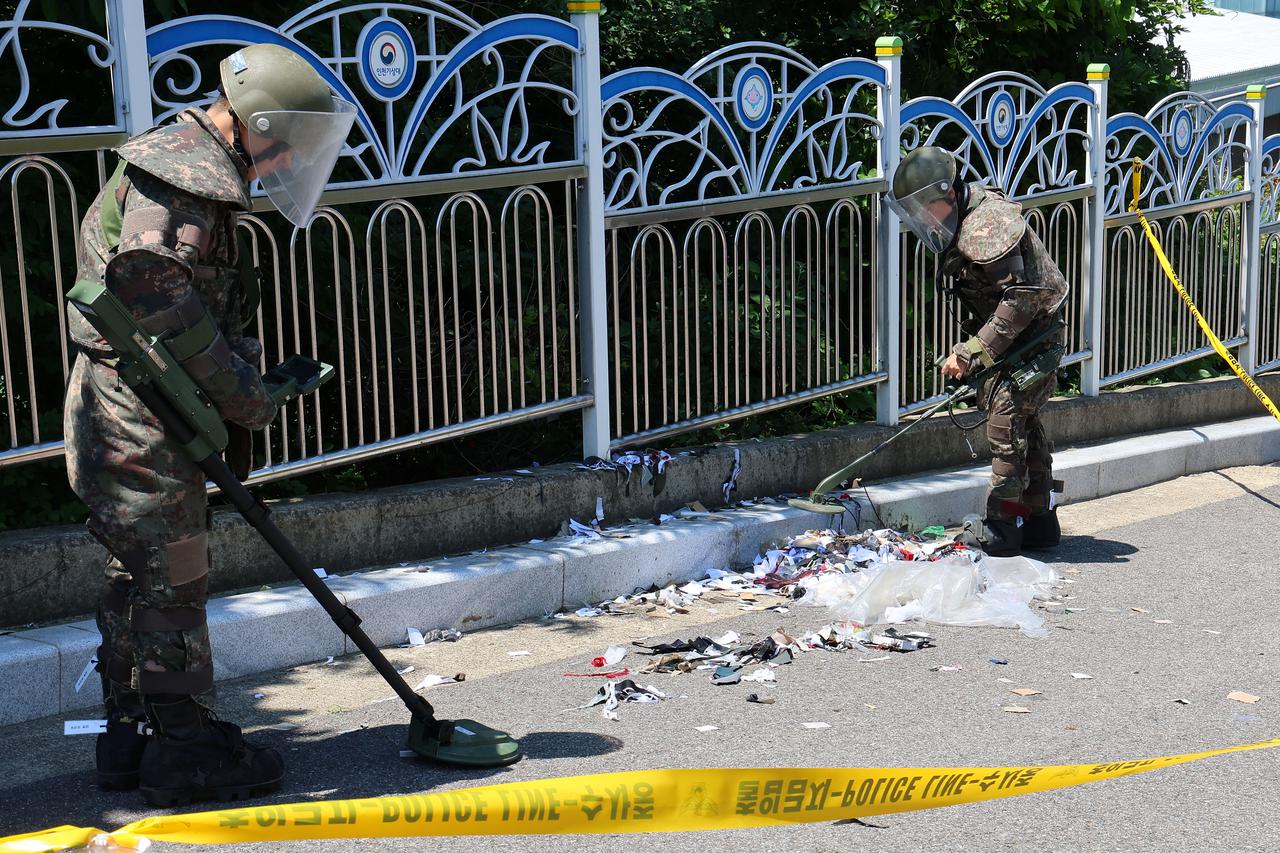 South Korean soldiers examine various objects including what appeared to be trash from a balloon believed to have been sent by North Korea, in Incheon