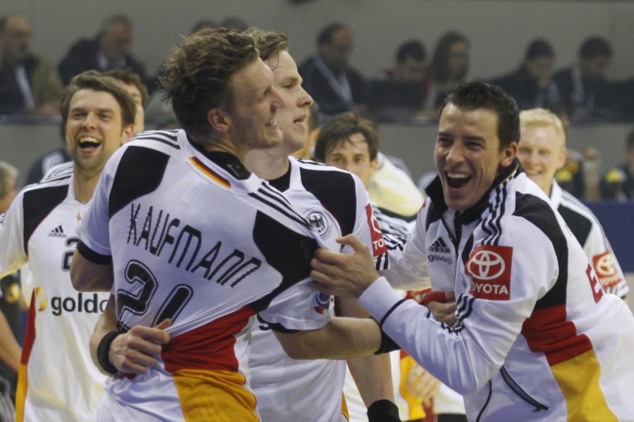 'German players celebrate their victory agaist Sweden during their Group B match at the Men\'s Handball European Championship in Nis January 19, 2012. REUTERS/Stoyan Nenov (SERBIA - Tags: SPORT HANDBA