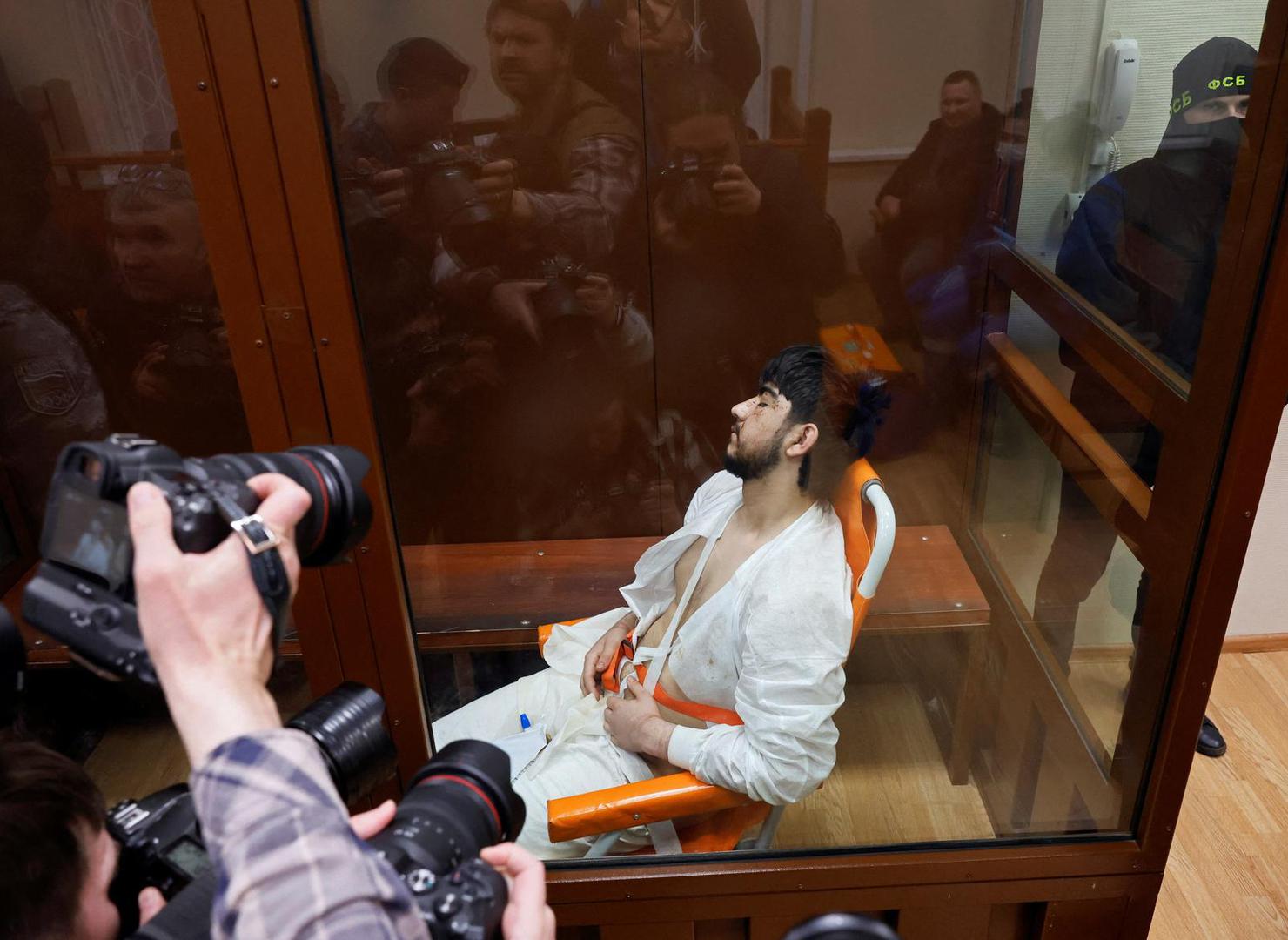 Muhammadsobir Fayzov, a suspect in the shooting attack at the Crocus City Hall concert venue, sits in a medical transport chair behind a glass wall of an enclosure for defendants before a court hearing at the Basmanny district court in Moscow, Russia March 25, 2024. REUTERS/Shamil Zhumatov Photo: SHAMIL ZHUMATOV/REUTERS