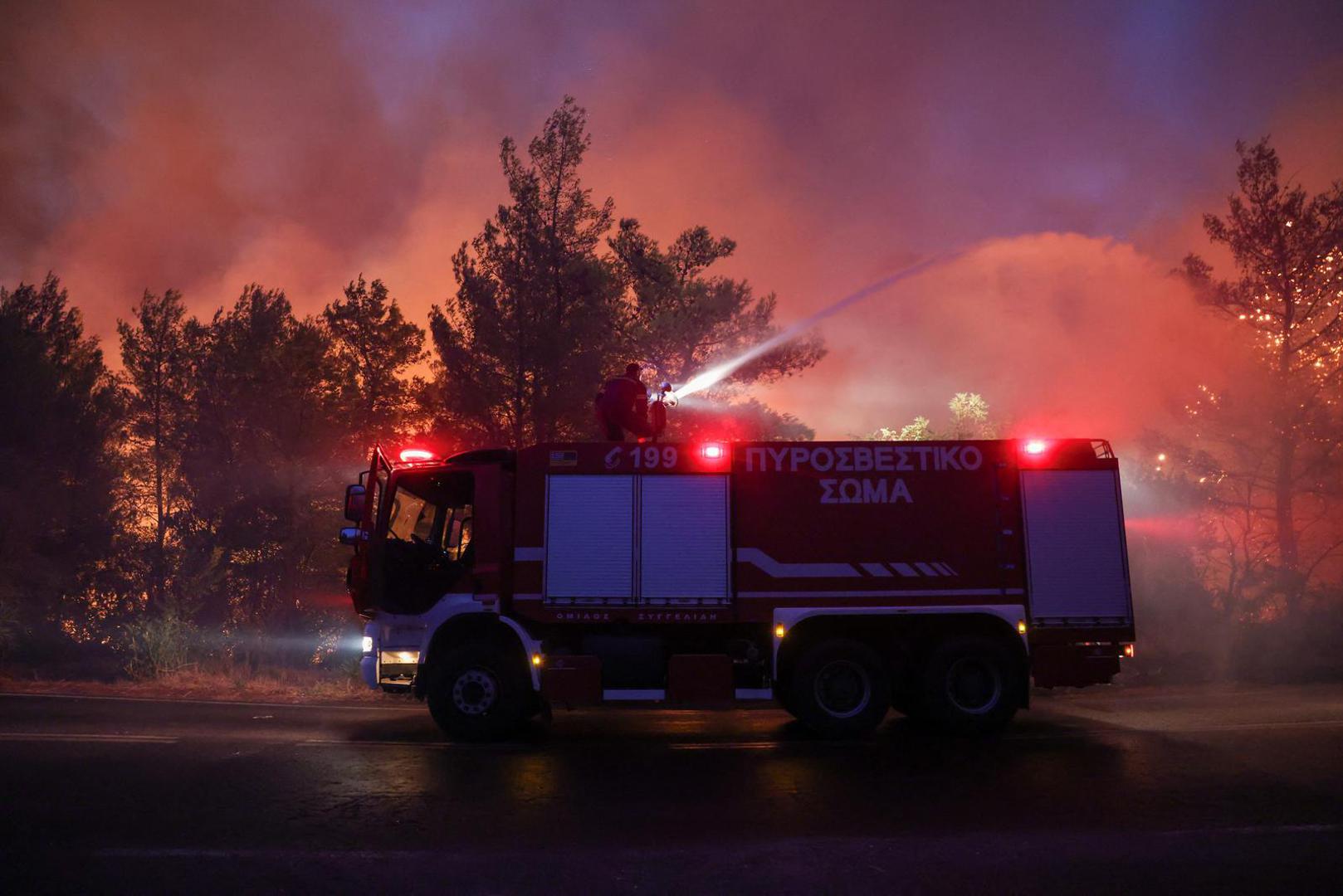 A firefighter tries to extinguish a wildfire burning in Dionysos, Greece, August 12, 2024. REUTERS/Alexandros Avramidis Photo: ALEXANDROS AVRAMIDIS/REUTERS