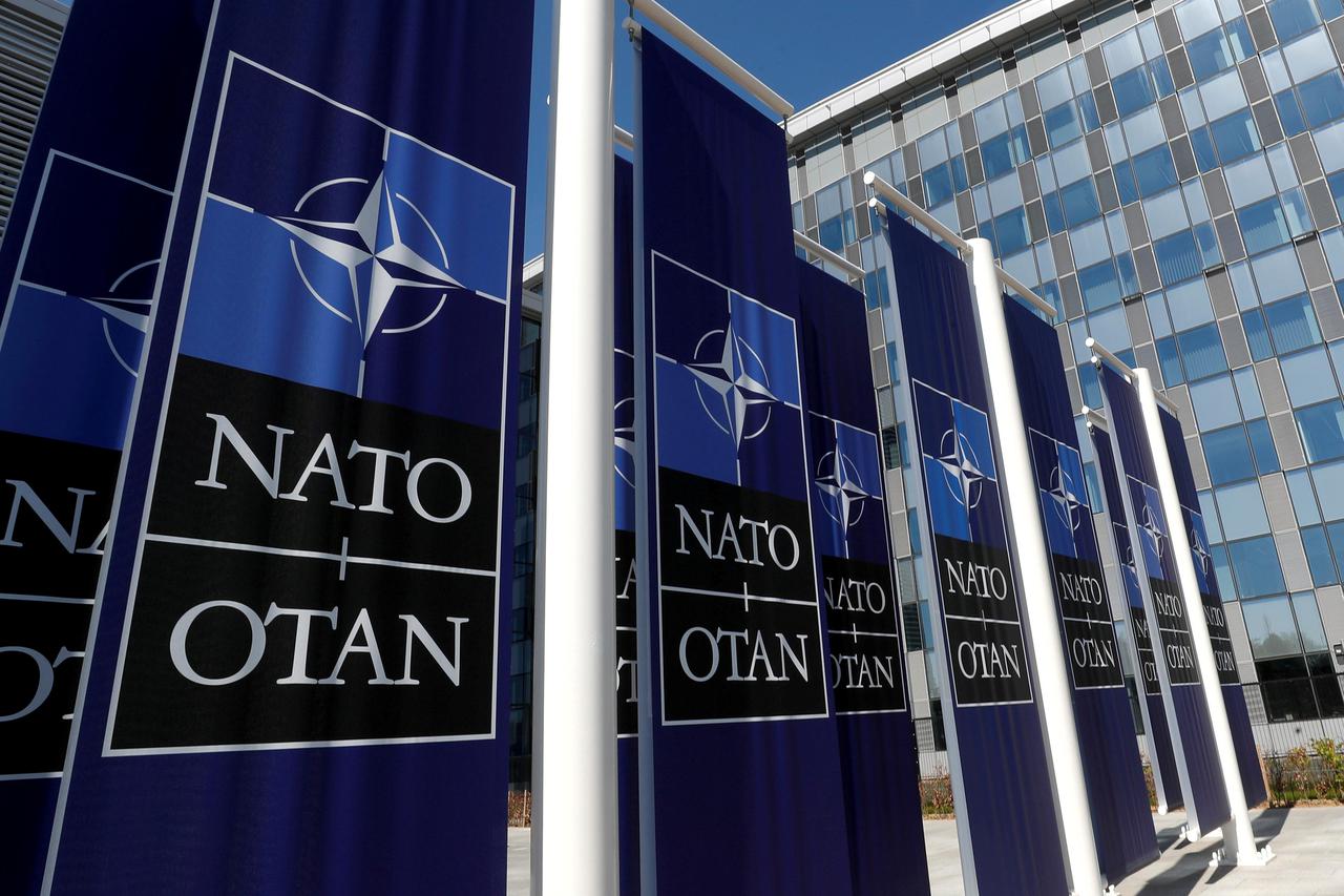 FILE PHOTO: Banners displaying the NATO logo are placed at the entrance of new NATO headquarters during the move to the new building