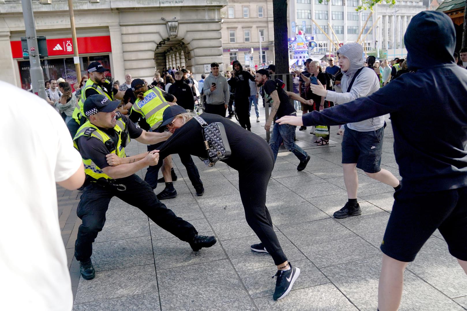 A police officer holds onto a woman during a protest in Nottingham Market Square following the stabbing attacks on Monday in Southport, in which three young children were killed. Picture date: Saturday August 3, 2024. Photo: Jacob King/PRESS ASSOCIATION