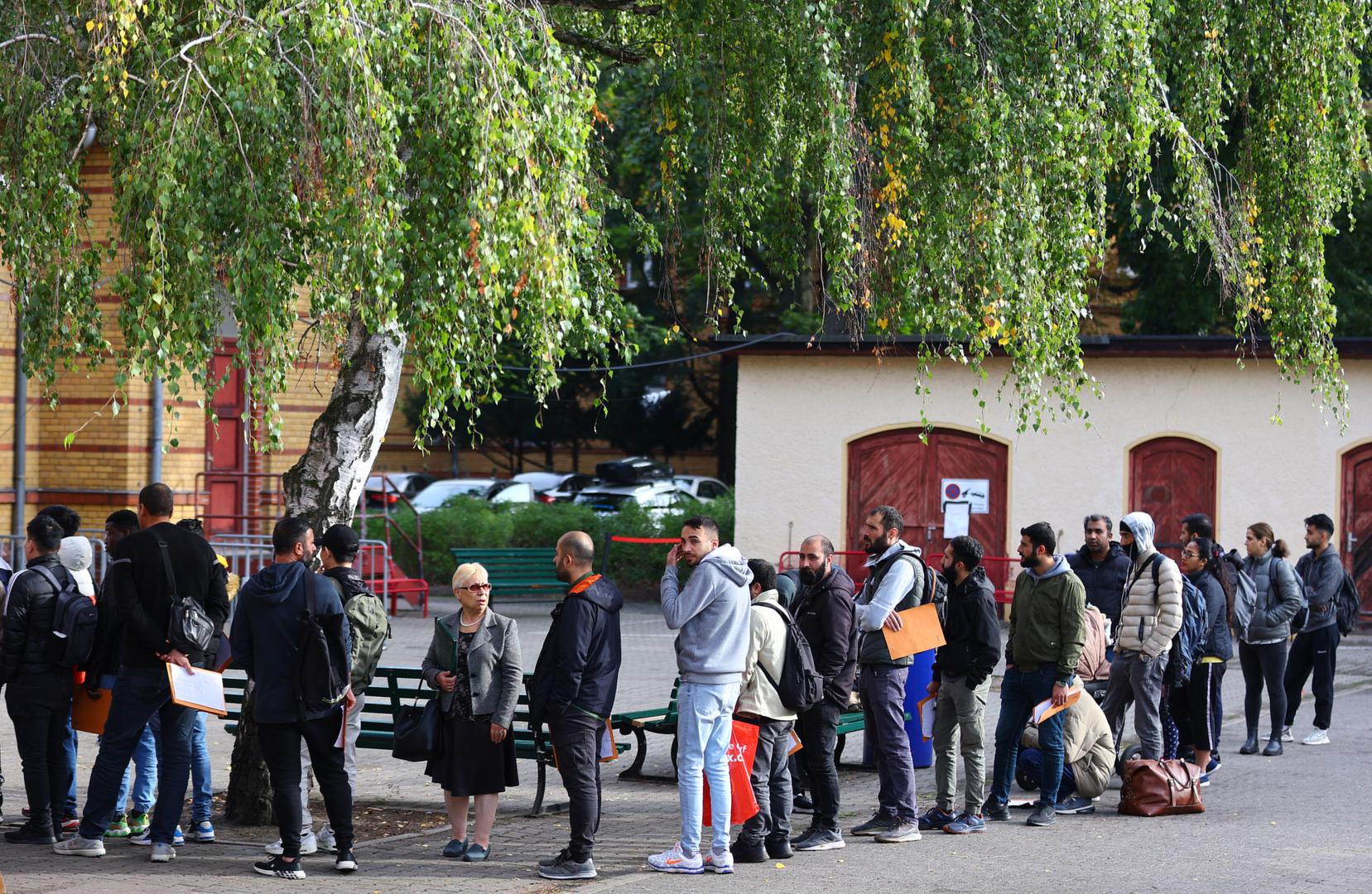 Migrants queue in a waiting area to be escorted to a registration office at the arrival centre for asylum seekers in Reinickendorf district, Berlin, Germany, October 6, 2023. REUTERS/Fabrizio Bensch Photo: Fabrizio Bensch/REUTERS