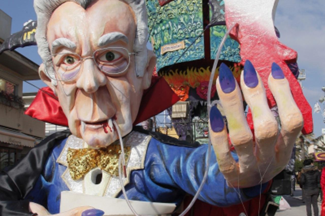 \'A carnival float showing Italian prime minister Mario Monti as a vampire parades during the carnival in Viareggio on February 5, 2012.   AFP PHOTO / FABIO MUZZI\'