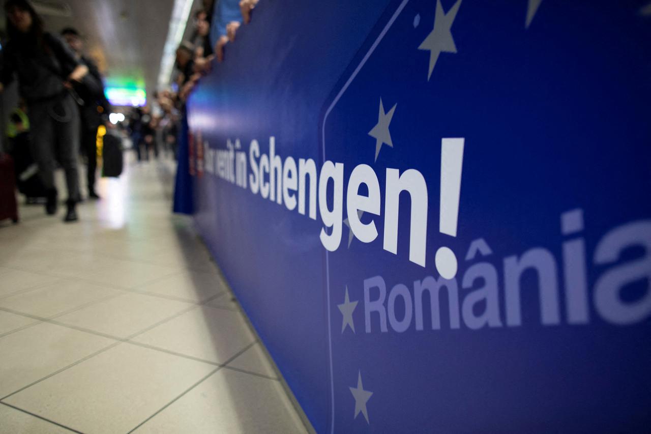 FILE PHOTO: A banner reading "Welcome to Schengen" is displayed at the arrivals section of Henri Coanda International Airport