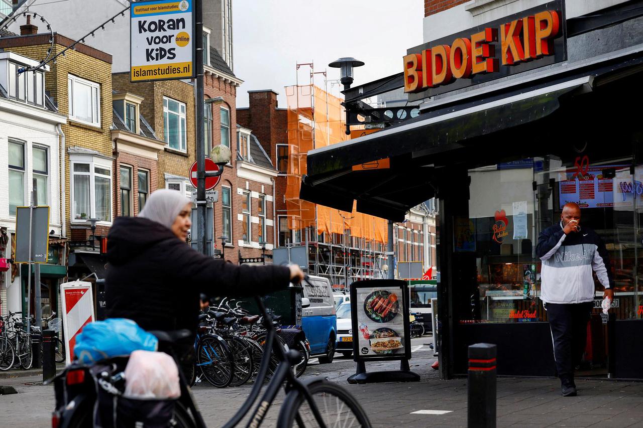 People walk past shops in Kanaalstraat, an immigrant-dominated area of Utrecht