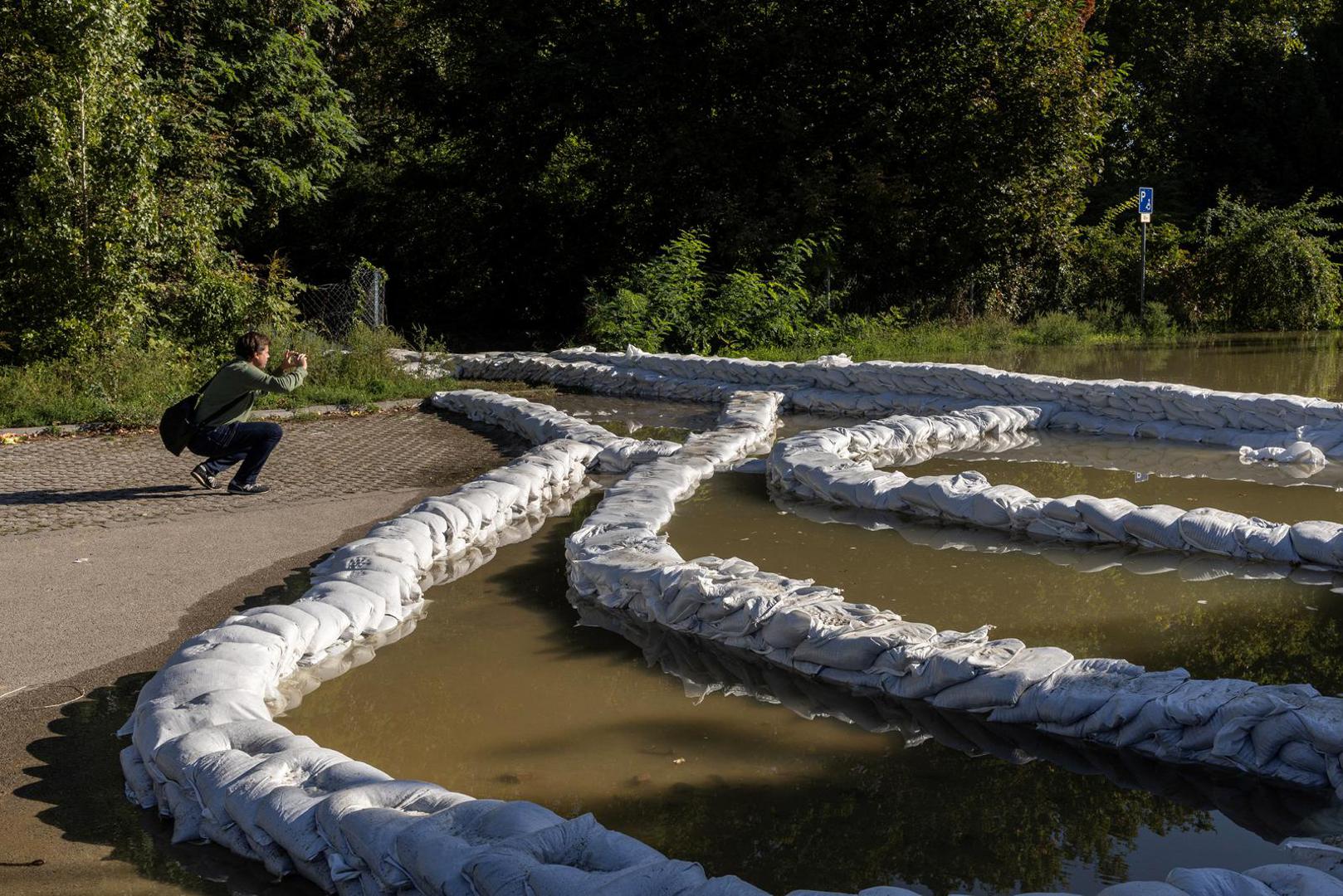 A man takes pictures of sandbags along a street flooded by the Danube river in Budapest, Hungary, September 21, 2024. REUTERS/Marko Djurica Photo: MARKO DJURICA/REUTERS