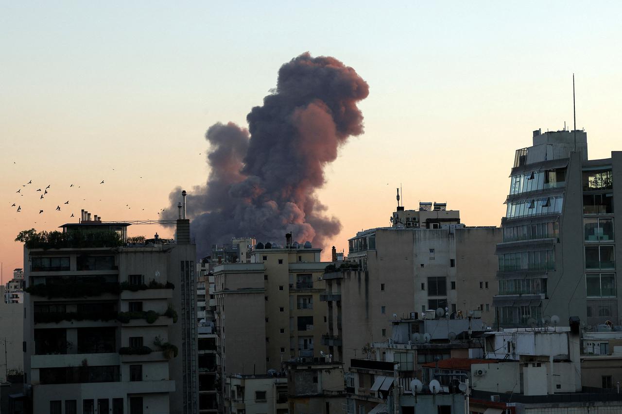 Smoke rises after explosions, in Beirut