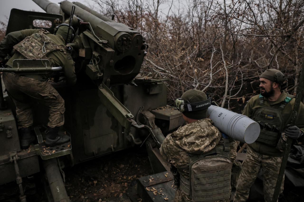 Ukrainian servicemen fire a self-propelled howitzer towards Russian troops at a frontline near the town of Chasiv Yar