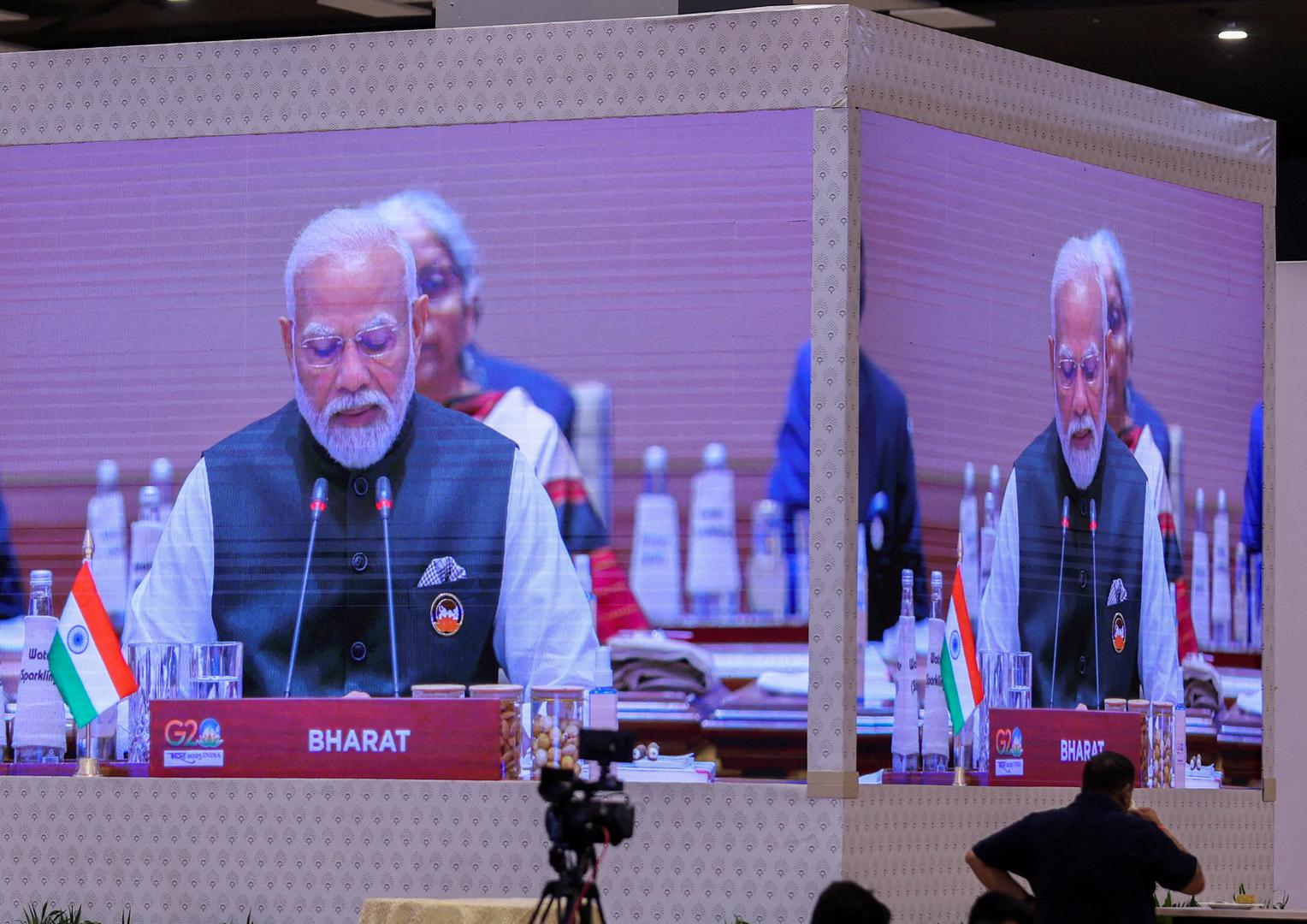 A giant screen displays India's Prime Minister Narendra Modi at the International Media Centre, as he sits behind the country tag that reads "Bharat", while delivering the opening speech during the G20 summit in New Delhi, India, September 9, 2023. REUTERS/Anushree Fadnavis     TPX IMAGES OF THE DAY Photo: ANUSHREE FADNAVIS/REUTERS