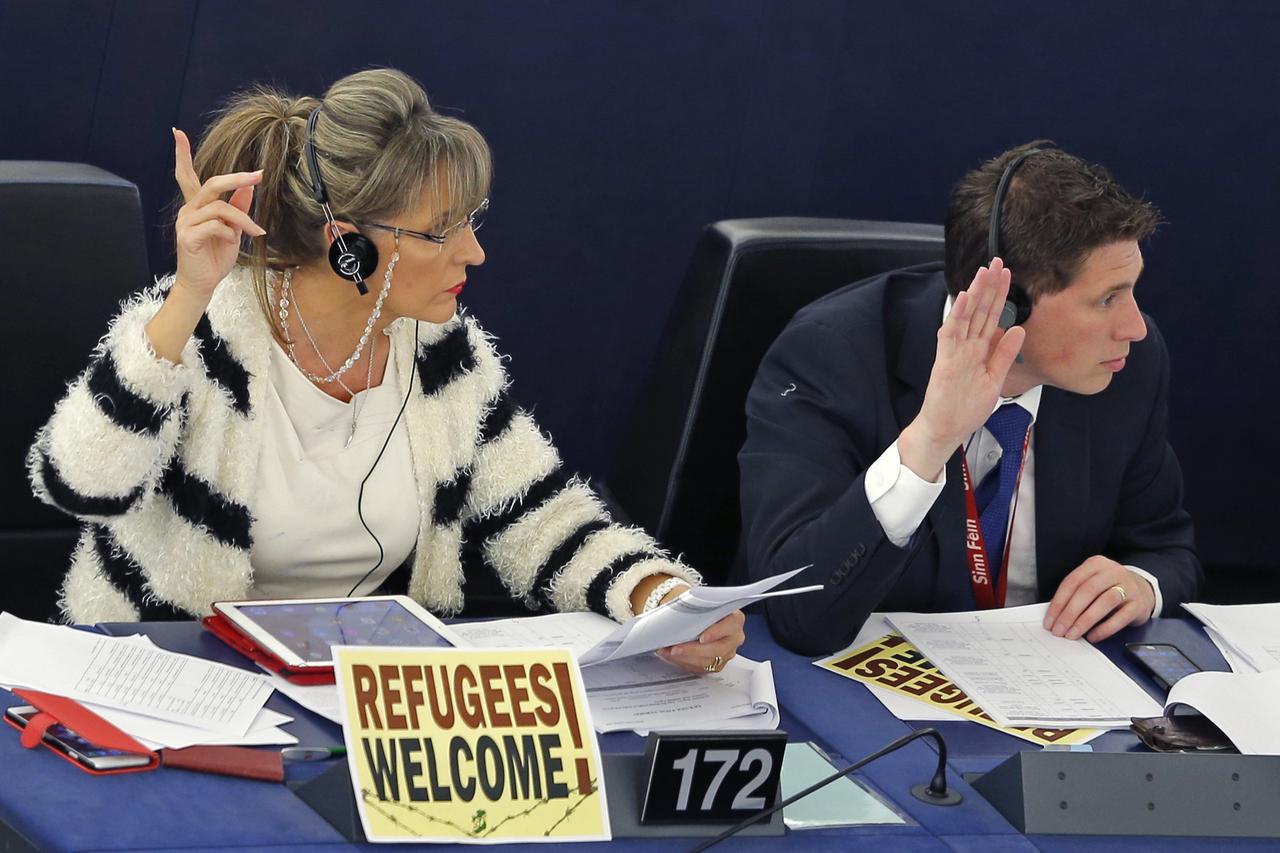 Members of the European Parliament take part in a voting session at the European Parliament in Strasbourg, France, September 8, 2015. The poster on the desk reads 