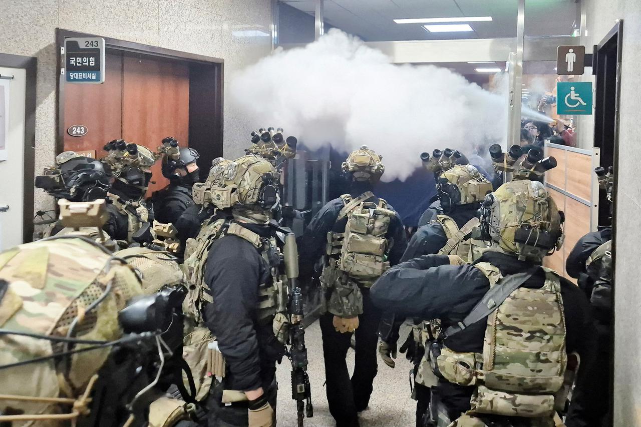 Soldiers advance to the main building of the National Assembly after South Korean President Yoon Suk Yeol declared martial law in Seoul