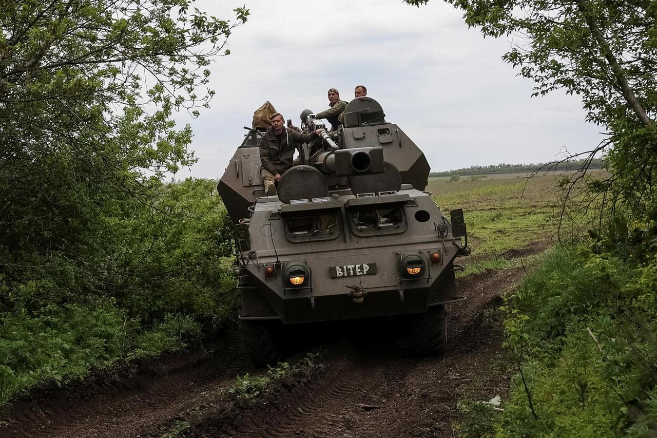 Ukrainian service members from a 110th Separate Mechanised Brigade of the Armed Forces of Ukraine, ride a self-propelled howitzer "Dana" near the town of Avdiivka