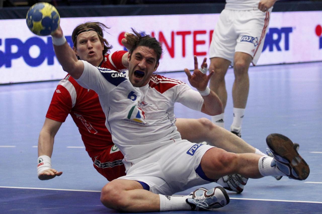 'France\'s Bertrand Gille (R) attempts to score next to Norway\'s Kjetil Strand during their main round match at the Men\'s Handball World Championship in Jonkoping January 24, 2011.        REUTERS/Um