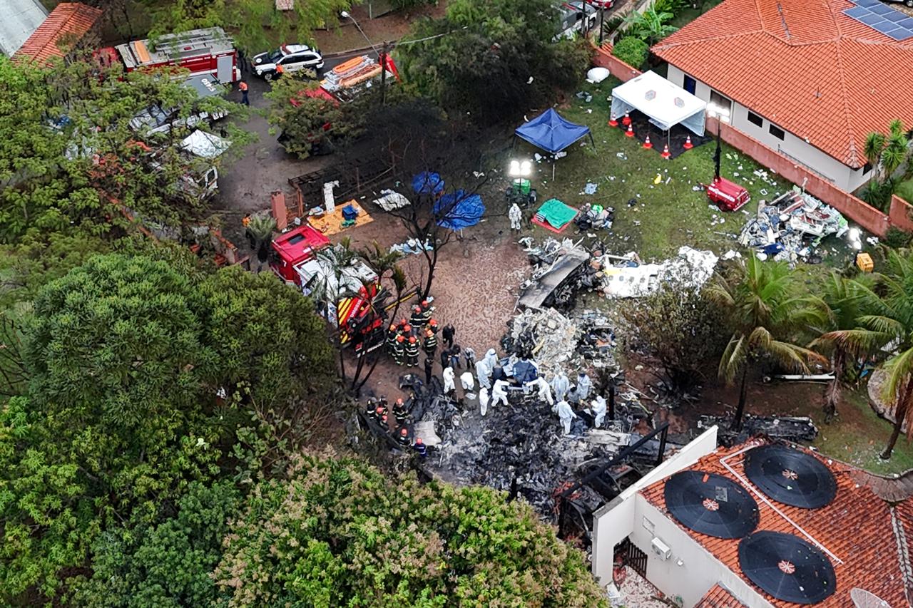 Officials work at the site of a plane crash in Vinhedo, Sao Paulo