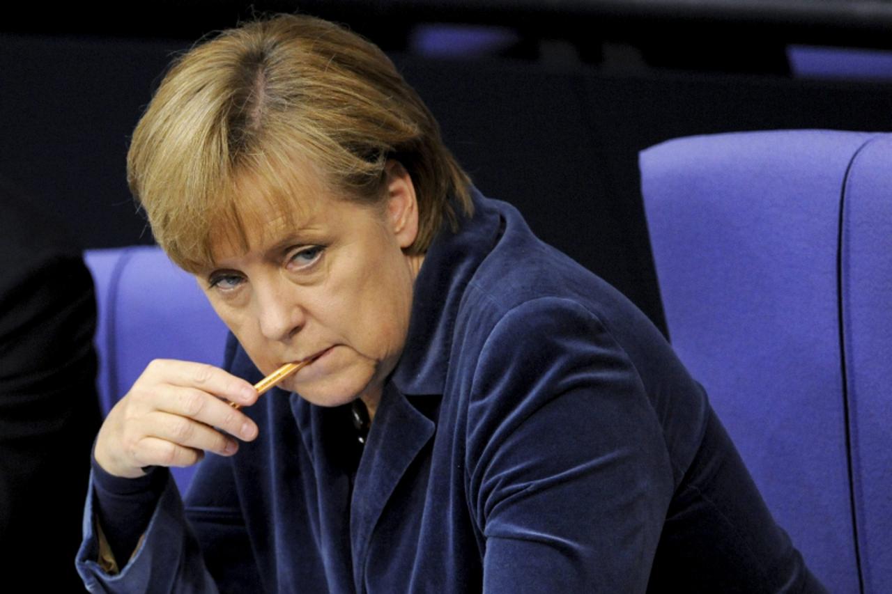 'epa02980852 German Chancellor Angela Merkel listens to the discussion on the expansion of the Euro rescue package EFSF at the Bundestag in Berlin, Germany, 26 October 2011. After the vote on the resc